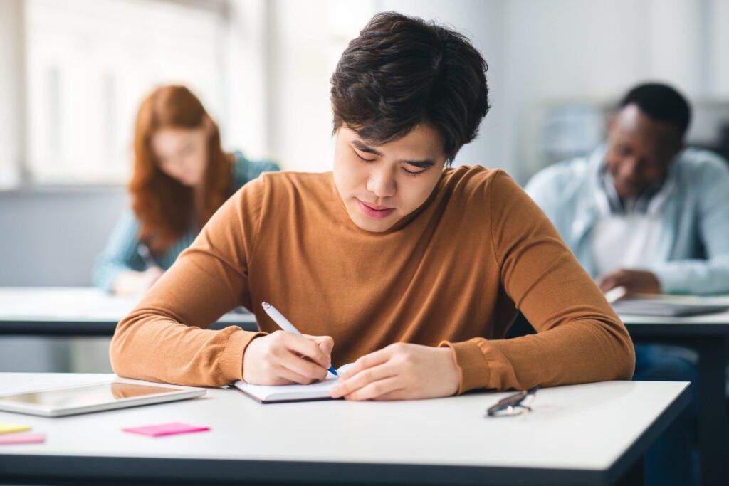 IELTS Max Holiday Course teacher providing one-to-one exam skills feedback to student.