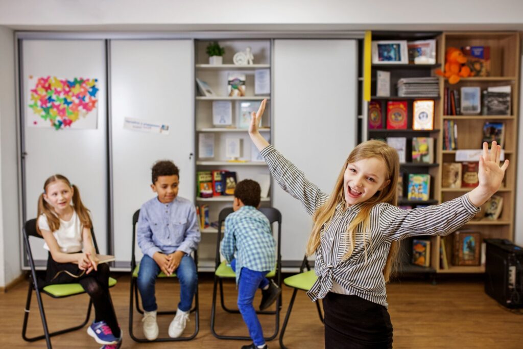 Children performing drama activities at the Holiday English Club for Kids, building English speaking confidence through Trinity Stars performances.