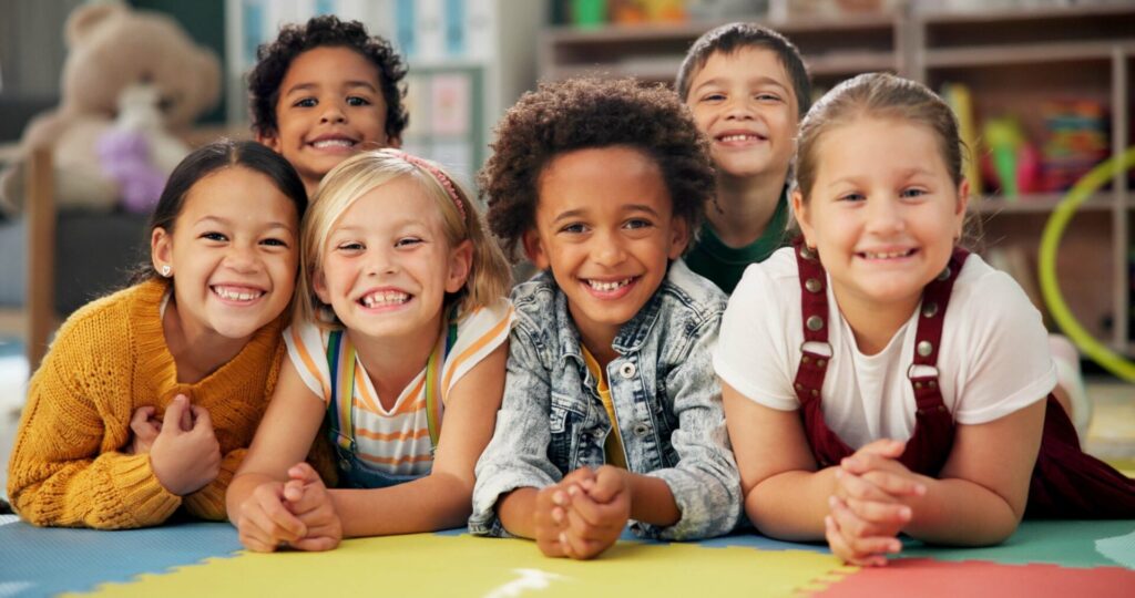 Smiling children in a small group English class at the Holiday English Club for Kids.