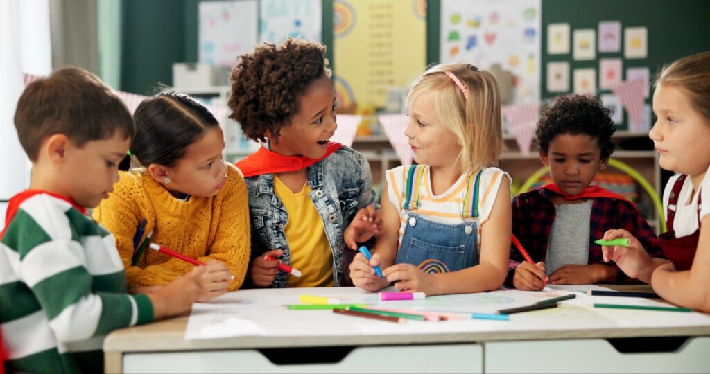 Group of children speaking and interacting during English activities at the Holiday English Club for Kids.