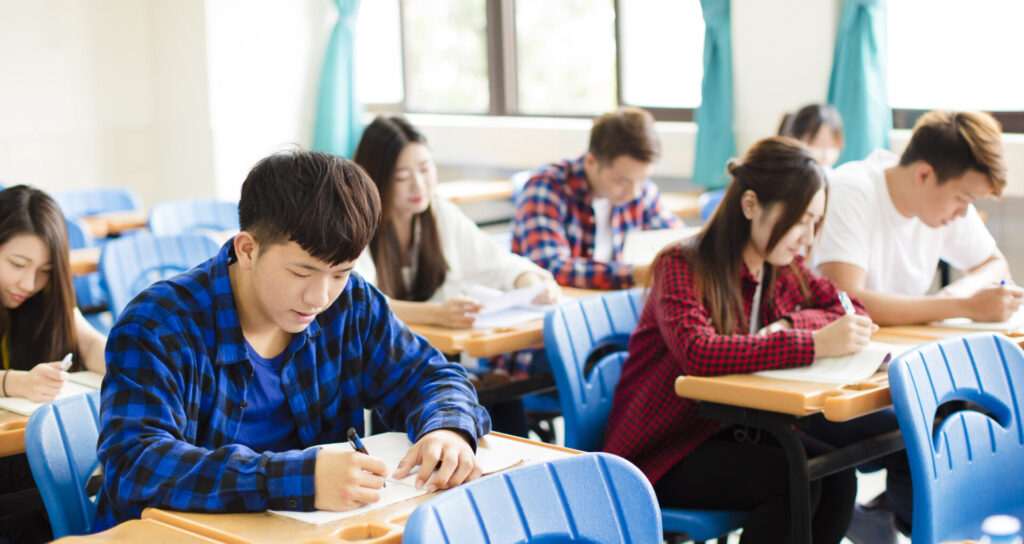 Students in classroom taking IELTS Max Holiday Course practice test at ILC Hua Hin