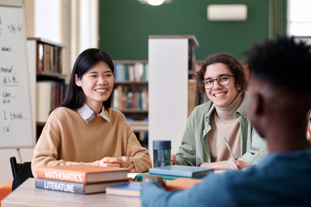 IELTS Exam Mastery students preparing in library with books