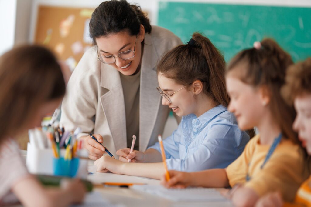 Teacher guiding students in a Trinity GESE English classroom activity.