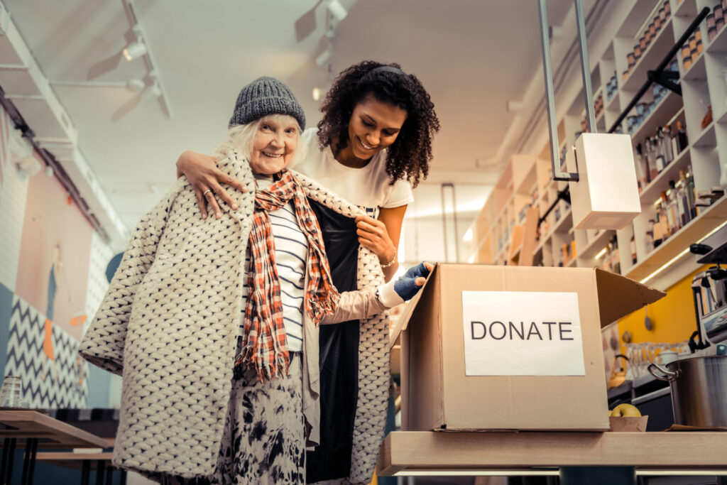 IELTS Society and Inequality 2025 – Woman donating clothes to support fairness and community