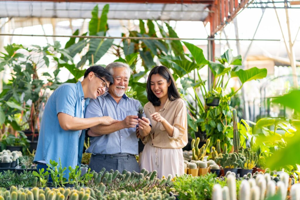 IELTS Family and Relationships in Thailand 2025 – three generations of a Thai family bonding while gardening together.