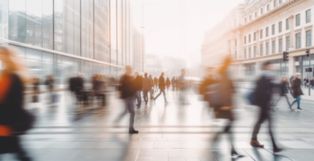 People walking quickly through a modern city street, representing IELTS Urbanisation and Cities exam themes in Thailand 2025.