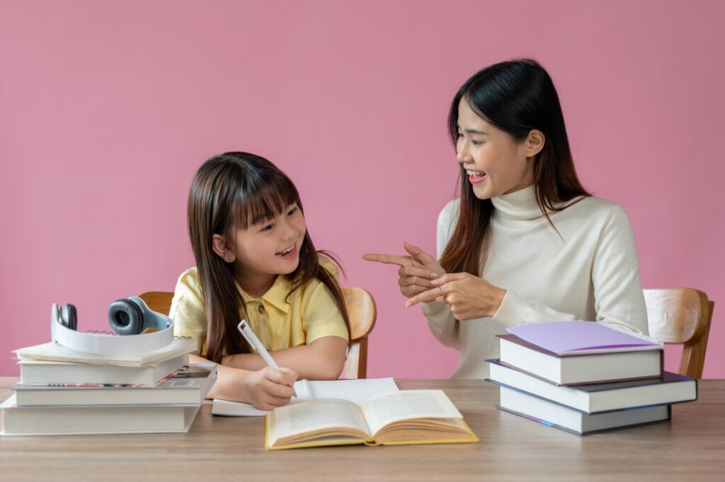 Intensive Beginner Coaching – Thai teacher helping young student learn English through Trinity GESE 1 preparation at ILC Hua Hin.