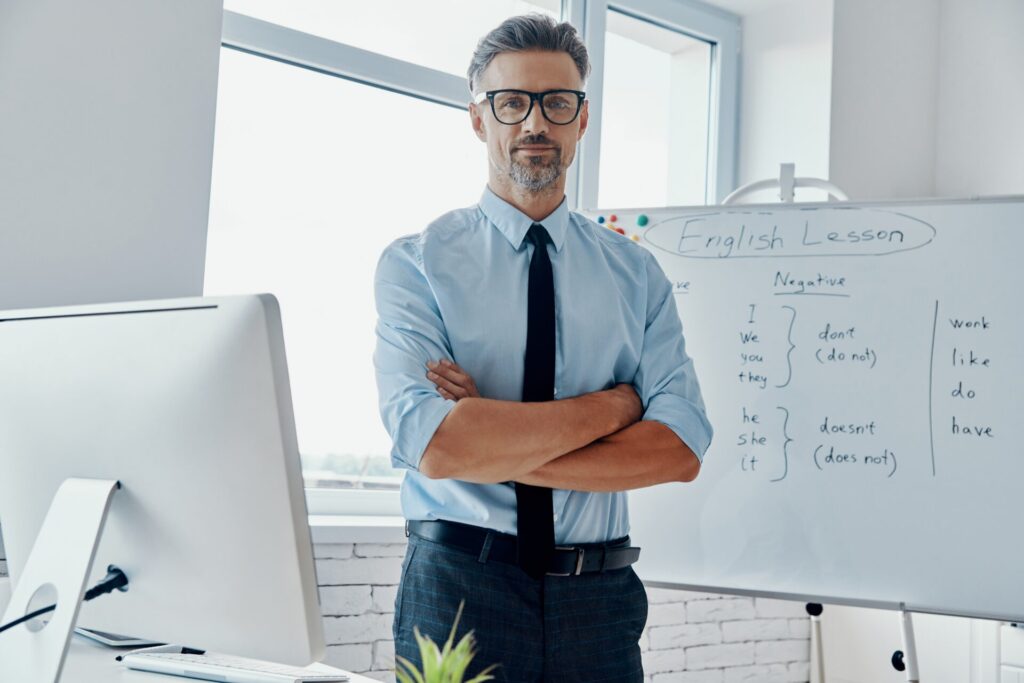 IELTS tuition in Thailand English teacher standing confidently in classroom at ILC Hua Hin